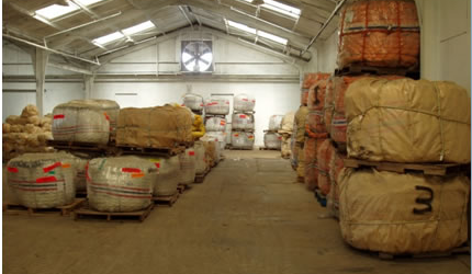 A warehouse filled with lots of boxes and pallets.